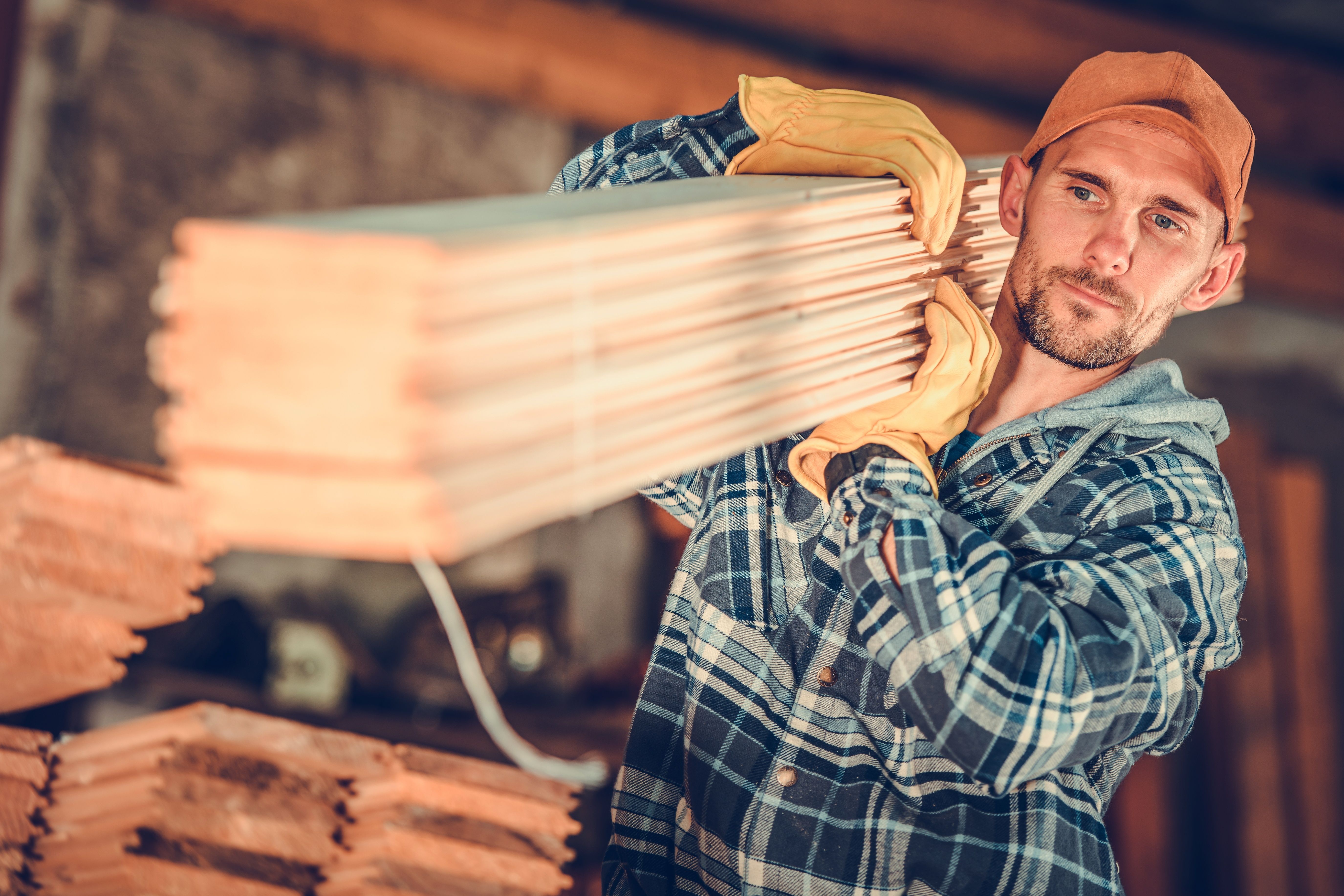 Contractor carrying lumber
